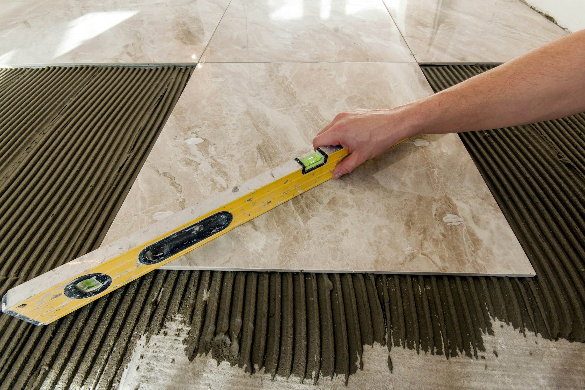 Ceramic tiles and tools for tiler. Floor tiles installation. Home improvement