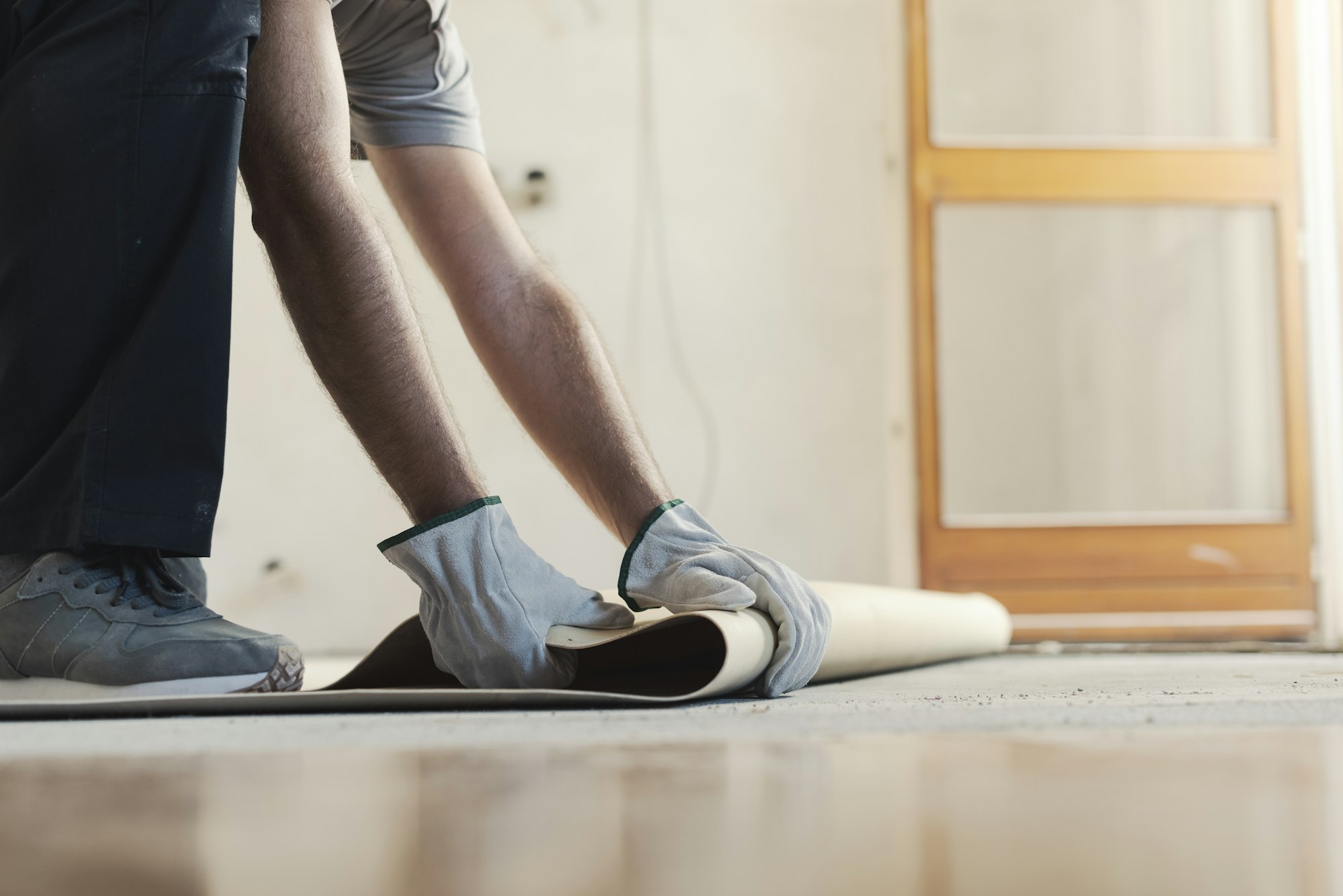 Contractor removing an old linoleum flooring