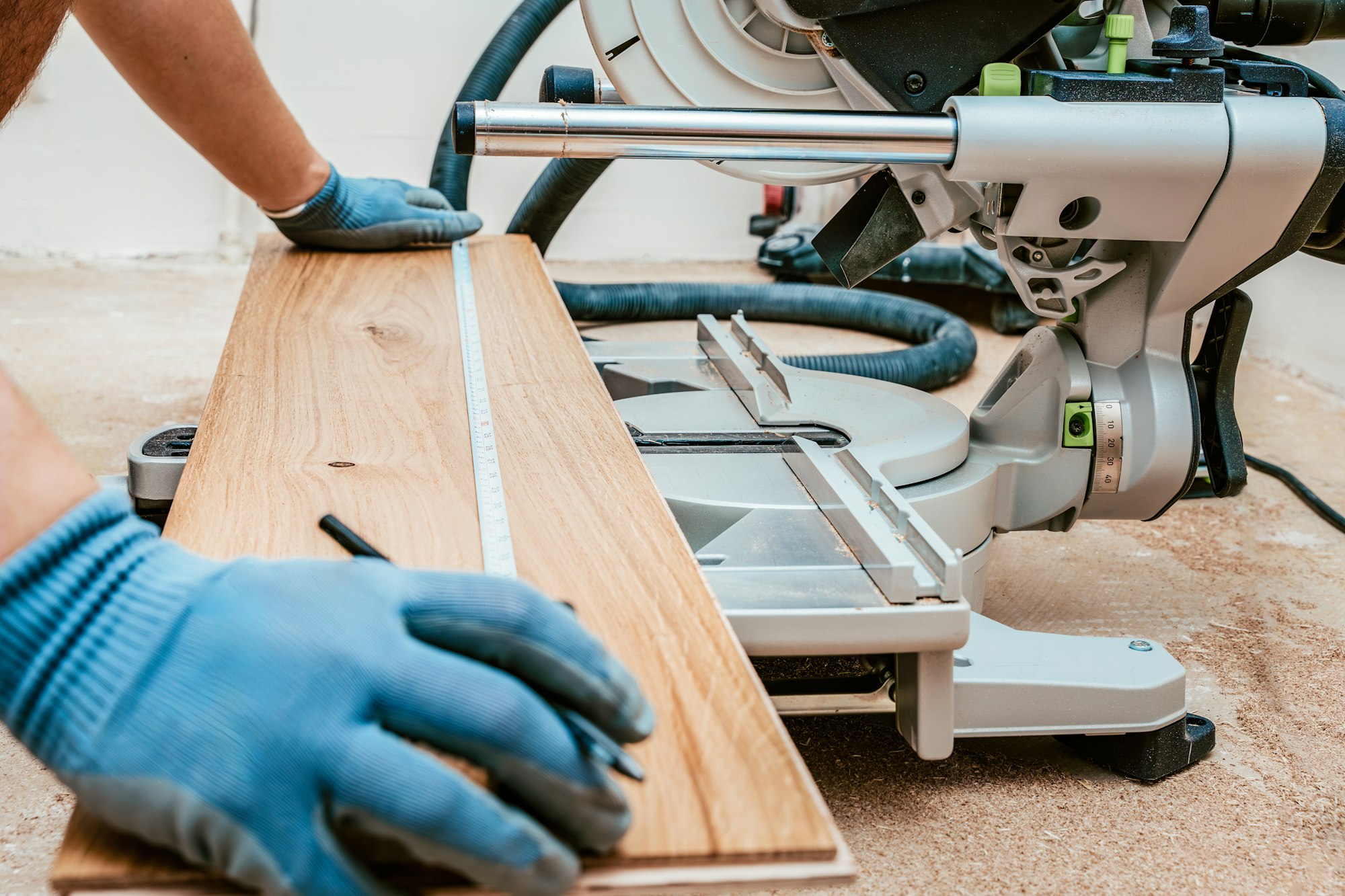 Preparing to Cut Wooden Plank for Flooring Installation